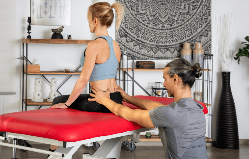 Physical therapist providing hands-on treatment for back pain in Chico