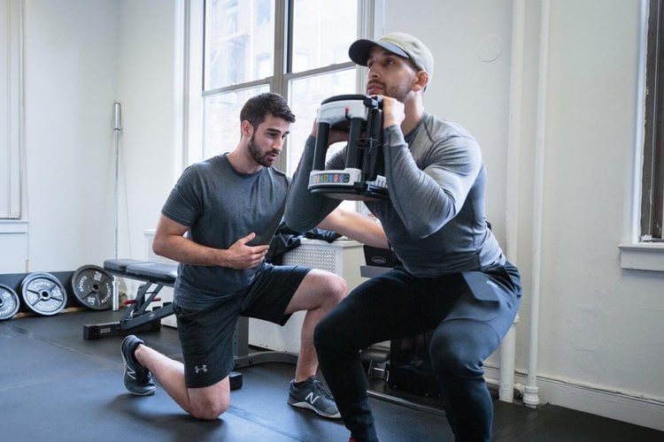 Inspire Physical Therapy coach guiding an active adult through a one-on-one strength session at the Chico studio